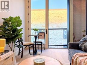 Hamilton apartment for rent - A living room with a couch, a chair, a table, and a plant.