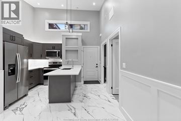 Lasalle apartment for rent - A modern kitchen with a marble floor and a refrigerator on the left.