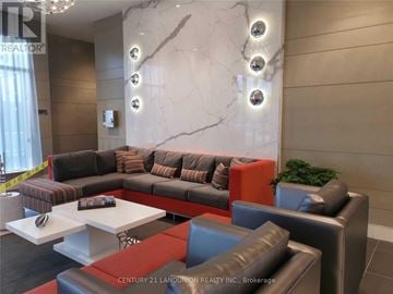Toronto (Henry Farm) condo for rent - A modern living room with a grey sofa and a white coffee table.