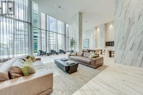 Mississauga (City Centre) condo for rent - A modern living room with a large window and a marble wall.