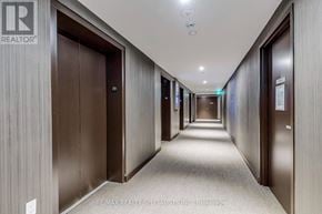 Mississauga (City Centre) condo for rent - A long hallway with doors on both sides and a RE/MAX Realty sign on the wall.