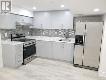 Mississauga (Meadowvale Village) apartment for rent - A modern kitchen with white cabinets and a stainless steel refrigerator.