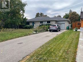 Mississauga (Streetsville) apartment for rent - A house with a car parked in front of it.