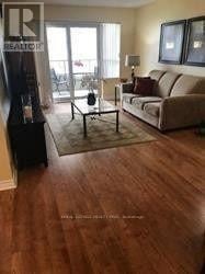 Mississauga (Hurontario) condo for rent - A living room with a couch, a coffee table, and a large window.