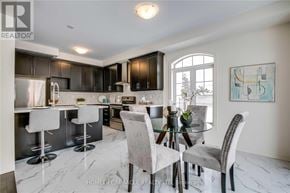 Brampton (Northwest Brampton) apartment for rent - A modern kitchen with a bar area and a dining table set up.