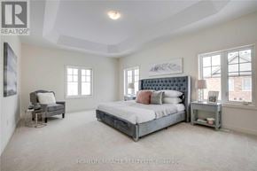 Brampton (Northwest Brampton) apartment for rent - A bedroom with a large bed and a chair.