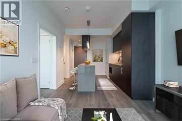 Toronto condo for rent - A modern living room with a grey sofa and a coffee table.