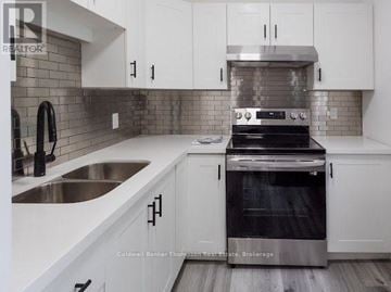 Huntsville fourplex for rent - A modern kitchen with white cabinets and a stainless steel oven.
