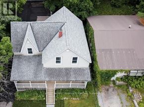 Huntsville fourplex for rent - A house with a grey roof and a red flag on it.