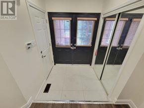 Mississauga (Meadowvale Village) apartment for rent - A white hallway with a black door and a white door.