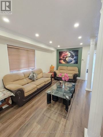 Mississauga (Meadowvale Village) apartment for rent - A living room with a beige couch and a glass coffee table.