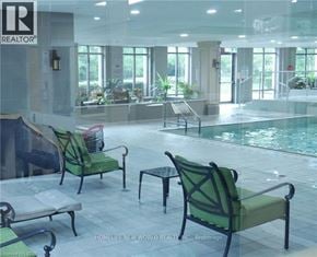 Toronto (West Humber-Clairville) condo for rent - A pool area with chairs and a sign that says REALTOR.