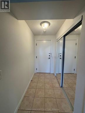 Toronto (West Humber-Clairville) condo for rent - A hallway with tiled floors and white walls.