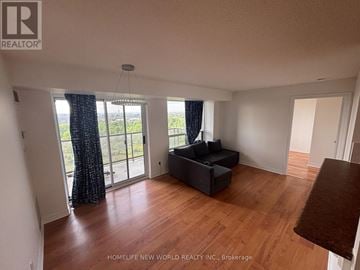 Toronto (West Humber-Clairville) condo for rent - A living room with a couch and a large window.