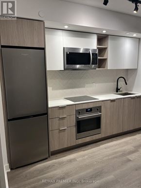 Toronto (Islington-City Centre West) condo for rent - A modern kitchen with a stainless steel refrigerator and oven.