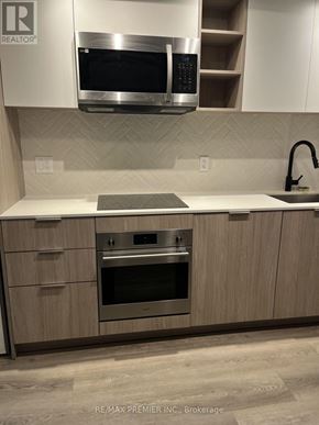 Toronto (Islington-City Centre West) condo for rent - A modern kitchen with a stainless steel oven and microwave above the counter.