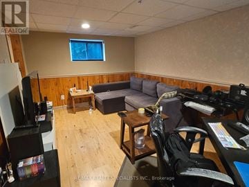 Mississauga (Meadowvale) apartment for rent - A living room with a grey couch and a wooden floor.