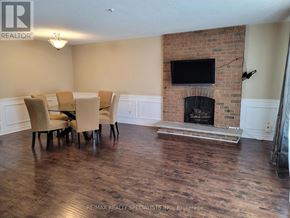 Mississauga (Meadowvale) apartment for rent - A living room with a fireplace and a TV mounted above it.