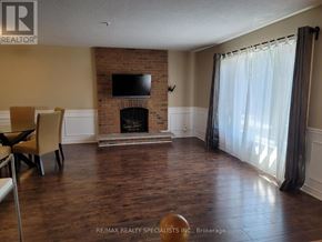 Mississauga (Meadowvale) apartment for rent - A living room with a fireplace and a flat screen TV.