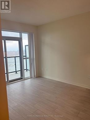 Toronto (Mimico) condo for rent - A room with a large window and sliding glass doors.