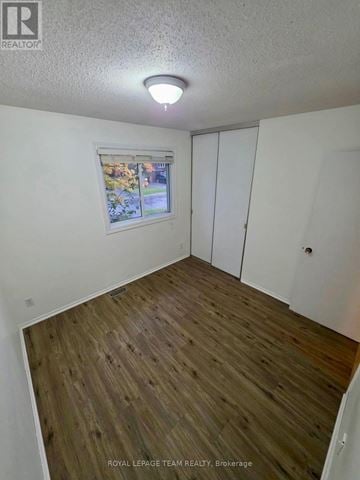 Ottawa townhouse for rent - A room with a window and wooden flooring.