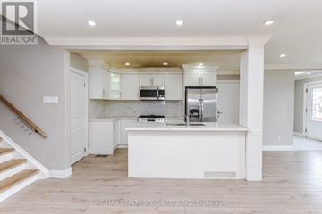 Brampton (Avondale) apartment for rent - A kitchen with white cabinets and a white island.
