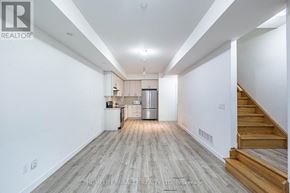 Brampton (Fletcher's Creek South) townhouse for rent - A spacious, well-lit kitchen and living room with wooden flooring and white walls.