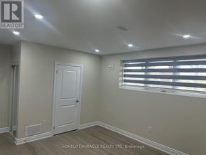 Brampton (Credit Valley) apartment for rent - A room with a door and a window with blinds.