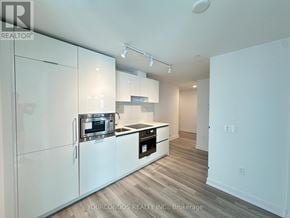 Toronto (Kensington-Chinatown) condo for rent - A kitchen with white cabinets and a stainless steel oven.