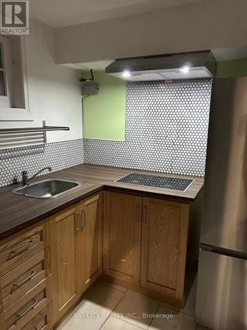 Toronto (Brookhaven-Amesbury) apartment for rent - A kitchen with wooden cabinets and a stainless steel refrigerator.