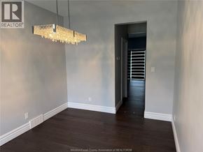 Windsor apartment for rent - A room with a chandelier hanging from the ceiling.