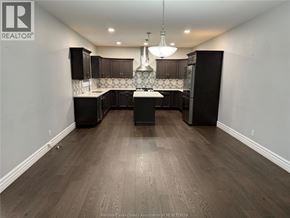 Windsor apartment for rent - A kitchen with dark wood floors and black cabinets.