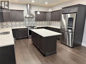 Windsor apartment for rent - A kitchen with a white island and dark wood cabinets.