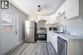 Windsor apartment for rent - A kitchen with stainless steel appliances and white cabinets.