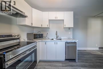 Windsor apartment for rent - A kitchen with white cabinets and stainless steel appliances.