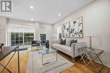 Whitby (Downtown Whitby) townhouse for rent - A modern living room with a glass coffee table and a white sofa.