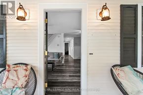 Fort Erie (Crystal Beach) apartment for rent - A white door opens to a hallway with a couch and a chair.