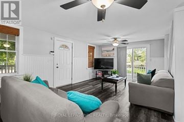 Fort Erie (Crystal Beach) apartment for rent - A living room with a grey couch and a television.