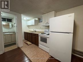 Richmond Hill (Crosby) apartment for rent - A kitchen with white appliances and brown cabinets.
