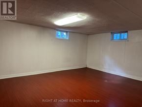 Richmond Hill (Crosby) apartment for rent - A room with wooden floors and two windows.