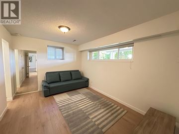 West Vancouver apartment for rent - A living room with a green couch and a striped rug.