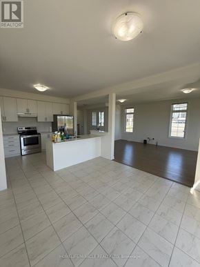 Loyalist (Bath) apartment for rent - A spacious kitchen with white cabinets and a large island.