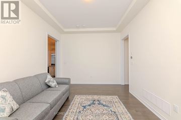 Aurora apartment for rent - A living room with a grey couch and a patterned rug.