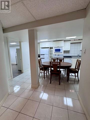 Vaughan (East Woodbridge) apartment for rent - A kitchen with a table and chairs in the middle of the room.