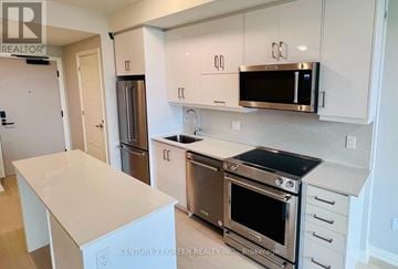 Oakville (Jm Joshua Meadows) condo for rent - A kitchen with white cabinets and stainless steel appliances.