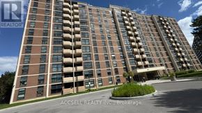 Toronto (Black Creek) condo for rent - A tall apartment building with a sign that reads "ACCSELL REALTY INC., Brokerage".