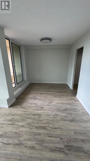 Toronto (Black Creek) condo for rent - A room with a wooden floor and a window.