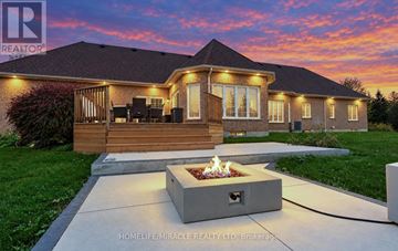 Milton (Campbellville) apartment for rent - A house with a fire pit in front of it at dusk.