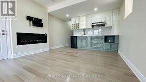 Brampton (Credit Valley) apartment for rent - A modern kitchen with a black fridge and a wooden floor.