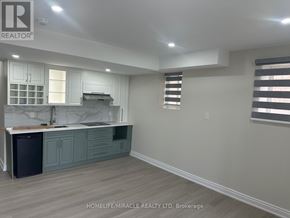 Brampton (Credit Valley) apartment for rent - A kitchen with a marble island and dark wood cabinets.